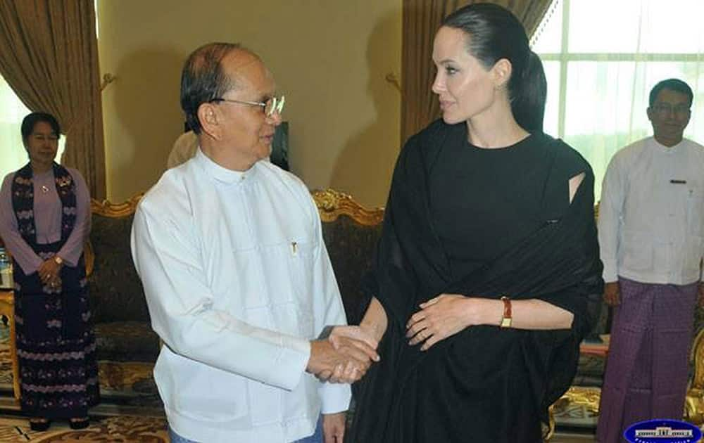 In this image released by the Myanmar President Office, Angelina Jolie Pitt shakes hands with President Thein Sein during their meeting at the presidential palace in Naypyitaw, Myanmar. 