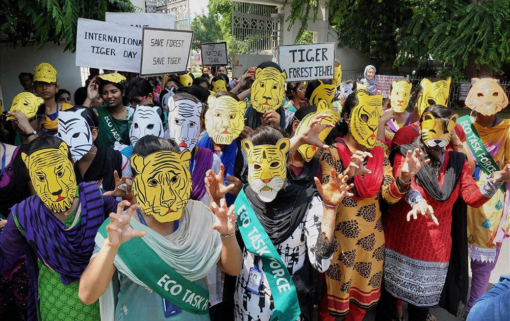 Students of Patna Womens College wear tiger masks to create awareness to save tigers on the occasion of International Tiger Day in Patna.