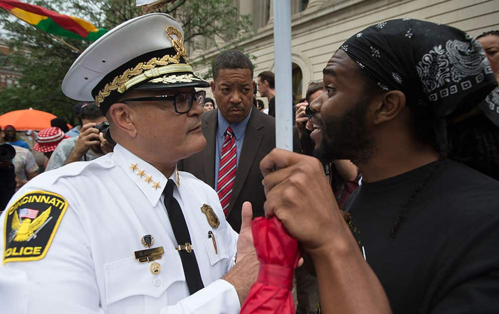 Cincinnati Police Chief Jeffrey Blackwell, left, speaks with a protestor during a demonstration outside the Hamilton County Courthouse after murder and manslaughter charges against University of Cincinnati police officer Ray Tensing were announced for the traffic stop shooting death of motorist Samuel DuBose in Cincinnati. 