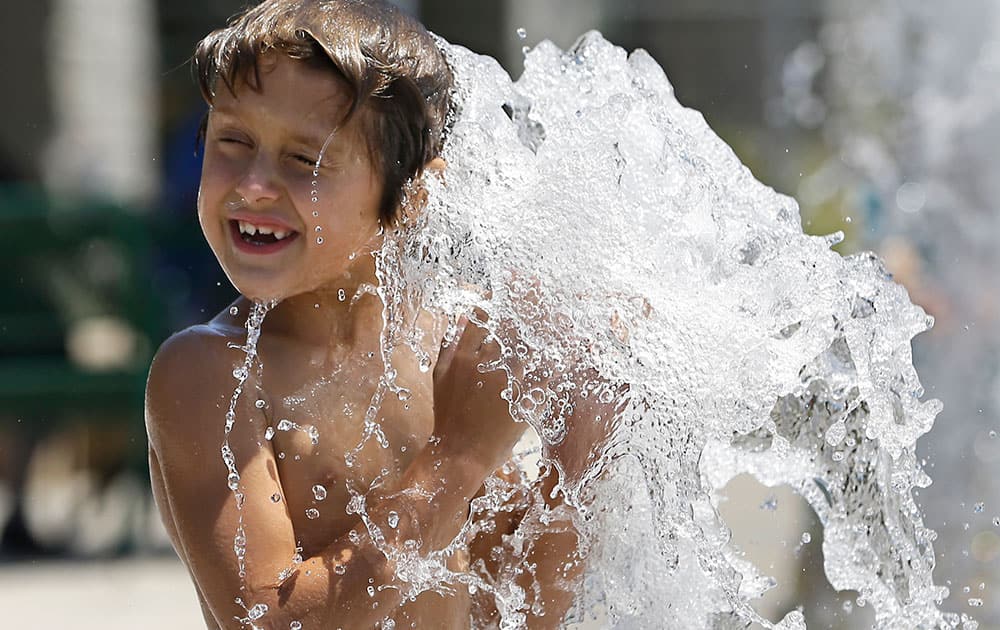 Richard Thornton, 7, cools off in the 