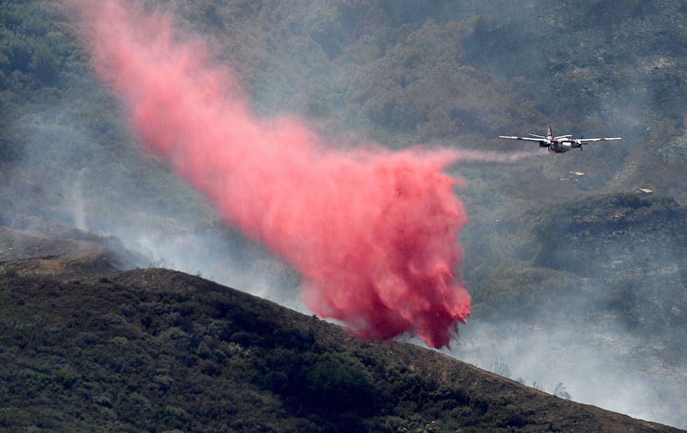 An air tanker makes a retardant drop on a wildfire in rural Solano County, Calif. 