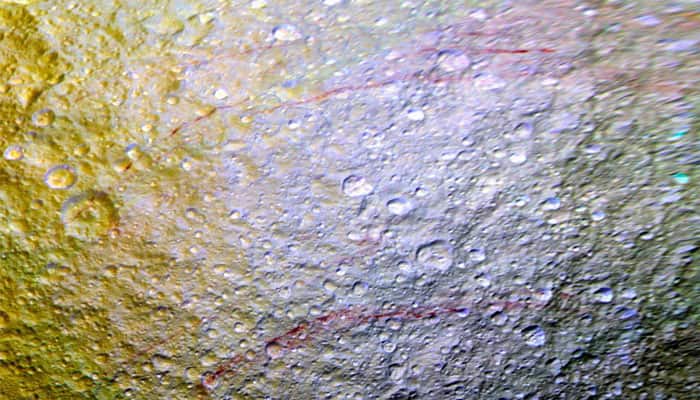 NASA probe spots unusual red arcs on icy Saturn moon