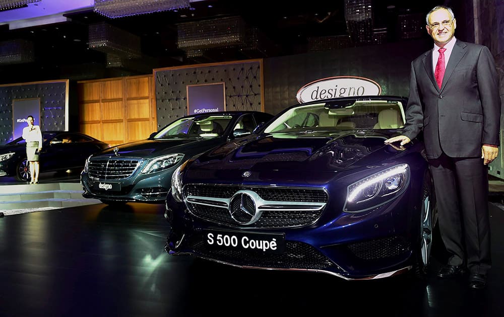 Managing Director and CEO of Mercedes-Benz India, Eberhard Kern, poses near Mercedes-Benz cars during a launch ceremony in New Delhi.