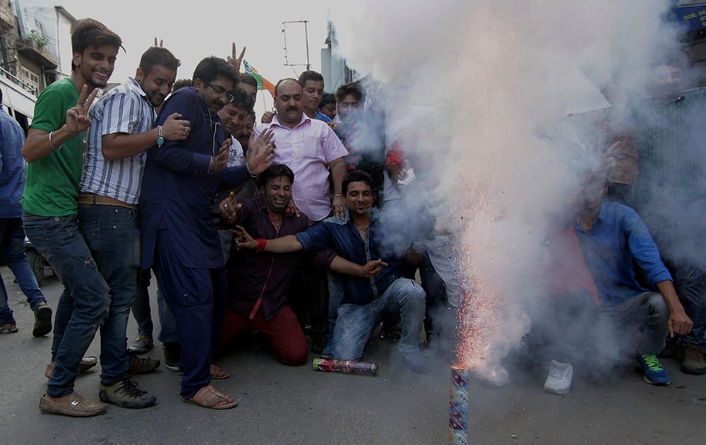 BJP workers burst crackers as they celebrate the announcement of AIIMS for Jammu by Union Health Minister JP Nadda, in Jammu.