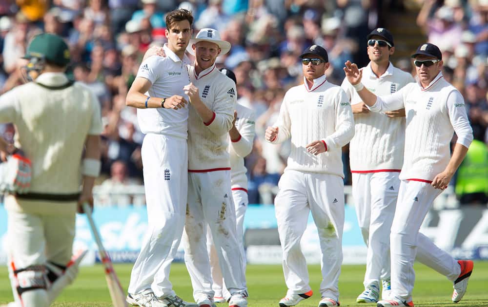 England's Steven Finn, second left, celebrates with teammates after bowling Australia's Mitchell Marsh for six on the second day of the third Test match of the five match series between England and Australia at Edgbaston cricket ground in Birmingham, England.