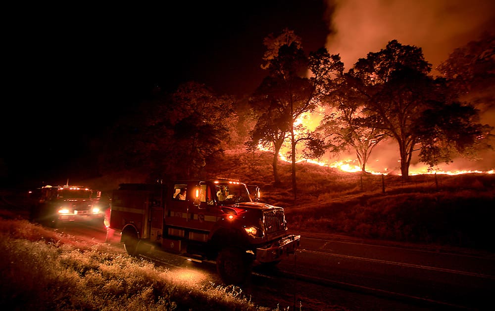 Cal Fire crews from Napa's Greenwood Ranch Station monitor a fire, near Lower Lake, Calif. 