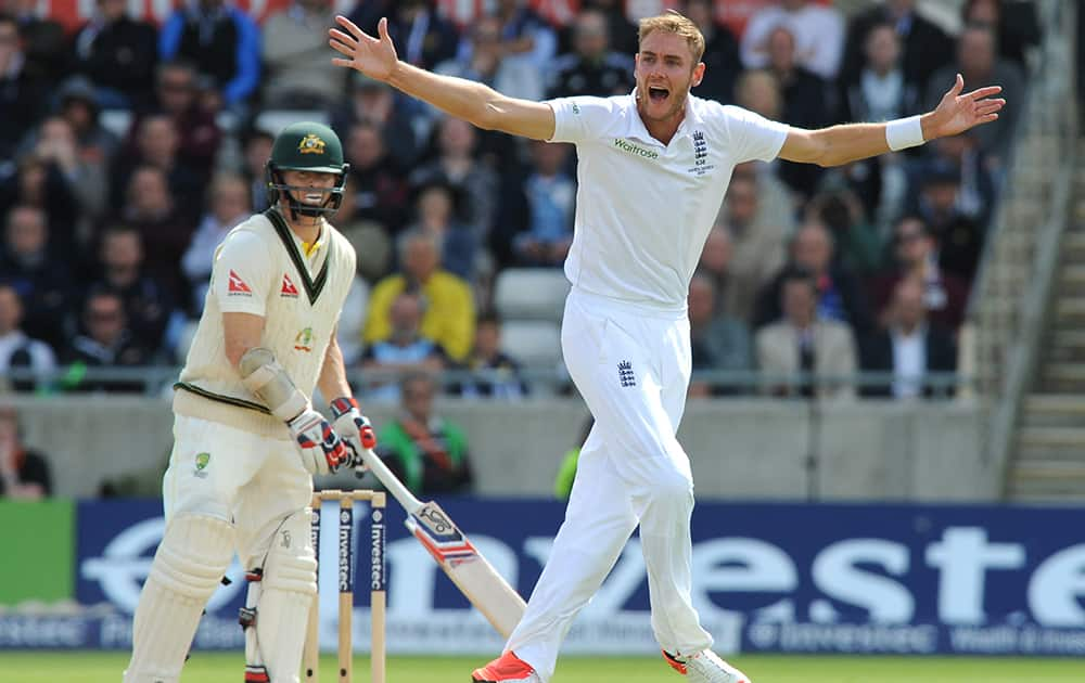 England’s Stuart Broad, right, celebrates after trapping Australia’s Chris Rogers, left, LBW for 6 runs during day two of the third Ashes Test cricket match, at Edgbaston, Birmingham, England.