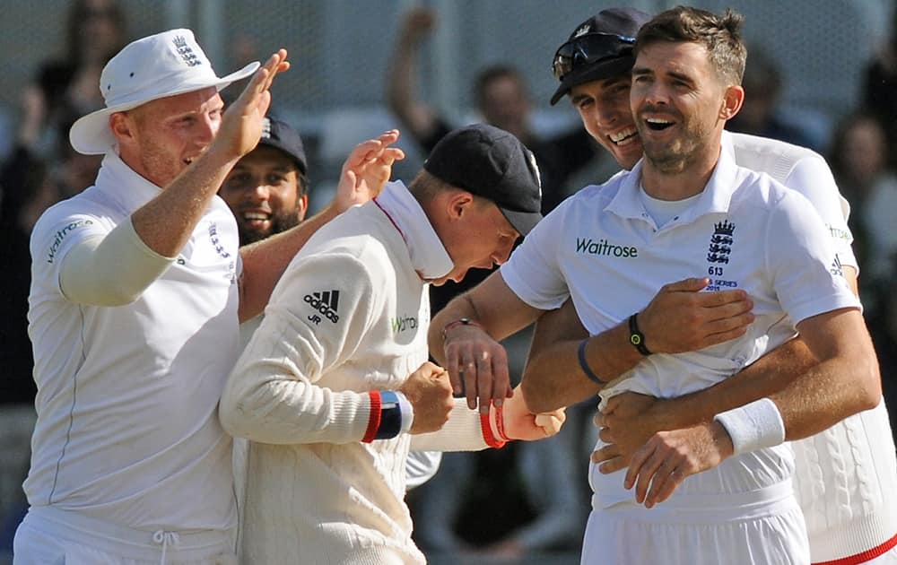 England’s James Anderson, celebrates with Steven Finn, 2nd right, Ben Stokes, left and Joe Root after bowling Australia’s David Warner, caught Adam Lyth for 77 runs during day two of the third Ashes Test cricket match, at Edgbaston, Birmingham, England.