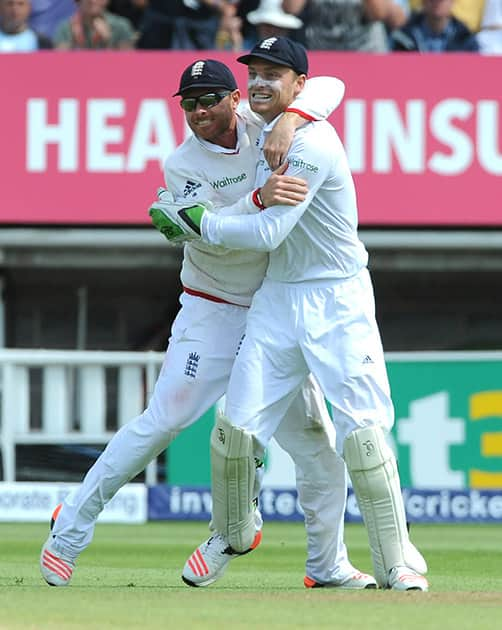 England’s Ian Bell celebrates with England’s Jos Buttler after Australia’s Peter Nevill is bowled by England’s Steven Finn caught Jos Buttler for 59 runs during day three of the third Ashes Test cricket match, at Edgbaston, Birmingham, England.