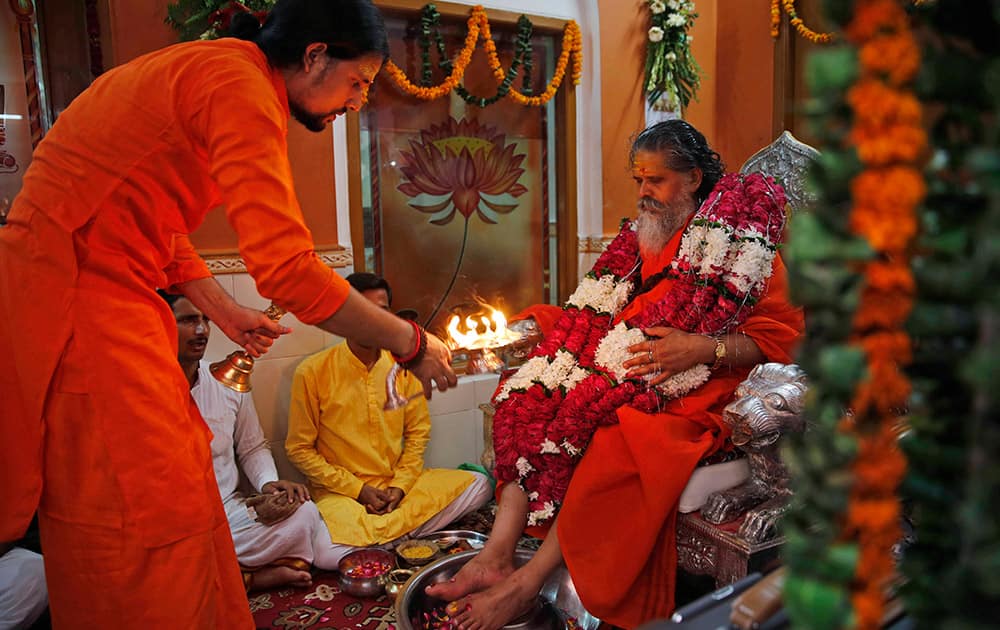 A Hindu devotee prays to his Guru on the occasion of Guru Purnima, or full moon day dedicated to the Guru, in Allahabad.