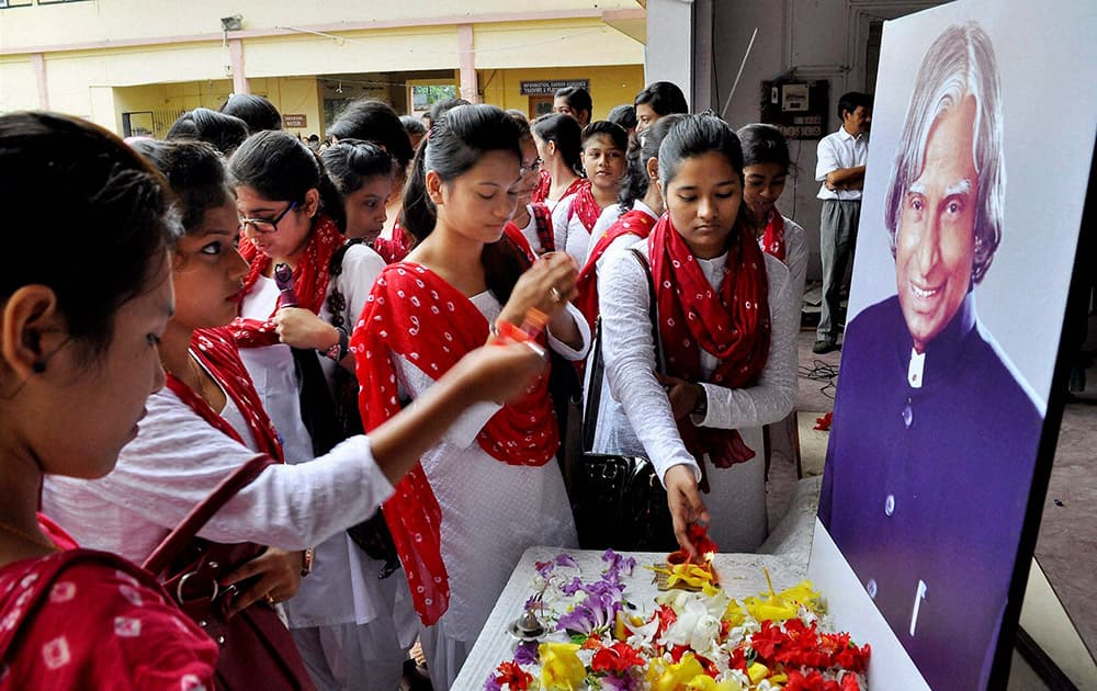 Students paying floral tribute on the portrait of former president APJ Abdul Kalam on the first day of college session at Handique Girls College in Guwahati.