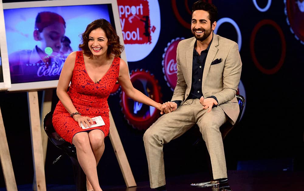 Bollywood actors Ayushmaan Khurana and Dia Mirza share a moment during the celebration of success of Support My School campaign in Bengaluru.