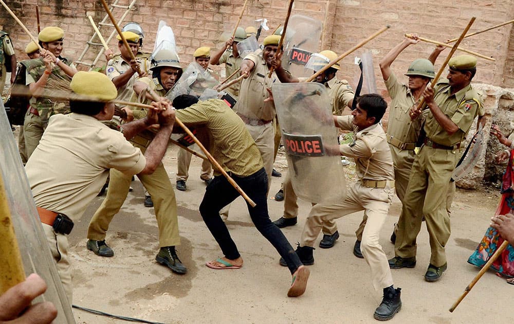 Police beating up a man who was protesting against removal of encroachments at Airport Road by the Municipal Corporation in Jodhpur.