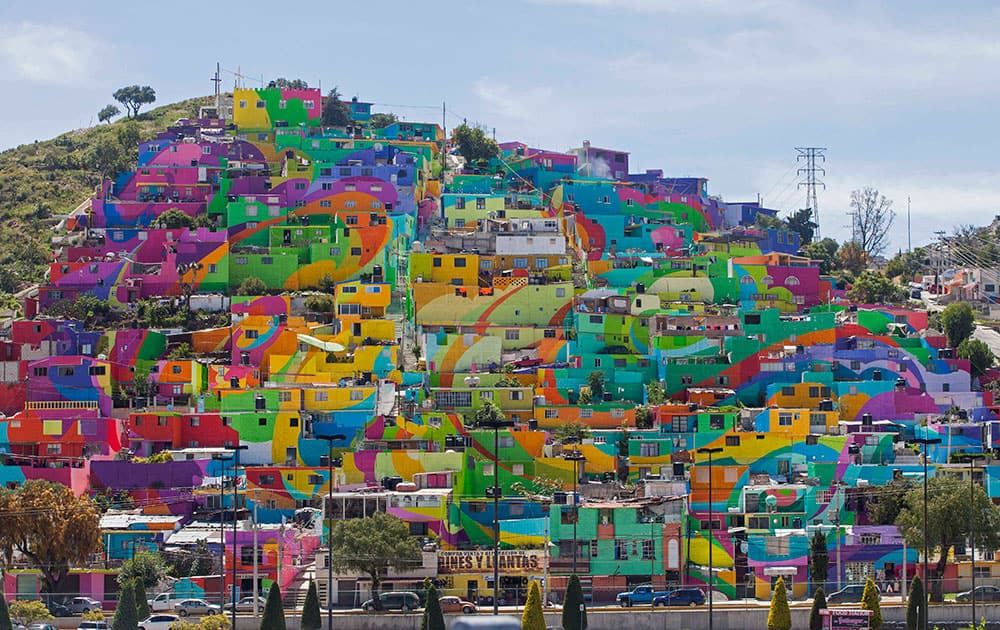 Hundreds of houses painted in bright colors in what organizers claim is Mexico's largest mural, is part of a government-sponsored project is called Pachuca Paints Itself, in the Palmitas neighborhood, in Pachuca, Mexico.