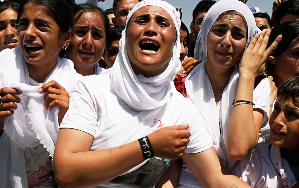 Yazidi Kurdish women chant slogans during a protest against the Islamic State group's invasion on Sinjar city one year ago, in Dohuk, northern Iraq.