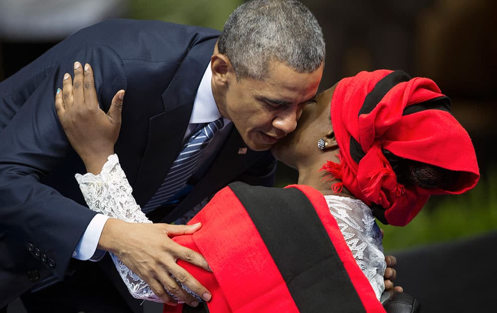 President Barack Obama hugs African singer Grace Alache Jerry after she announced him onstage prior to his speaking at the Young African Leaders Initiative (YALI) Mandela Washington Fellowship Presidential Summit in Washington.