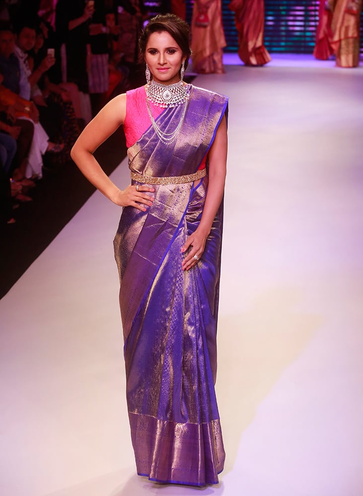 Sania Mirza displays the creations of Moni Agarwal during a fashion show at the India International Jewellery Week in Mumbai.