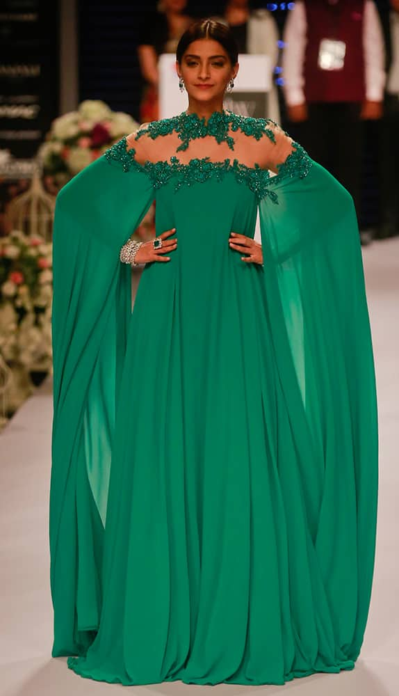 Sonam Kapoor greets as she walks the ramp during a fashion show at the India International Jewellery Week in Mumbai.