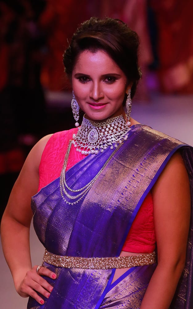 Sania Mirza displays the creations of Moni Agarwal during a fashion show at the India International Jewellery Week in Mumbai.