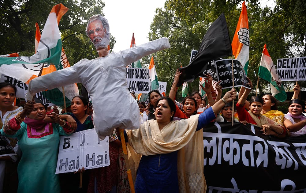 India's opposition Congress party workers carrying an effigy of Prime Minister Narendra Modi protest outside the office of the ruling Bharatiya Janata Party (BJP) in New Delhi.