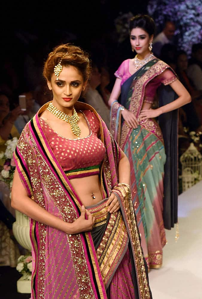 Model walk the ramp during a fashion show at India International Jewellery Week in Mumbai.