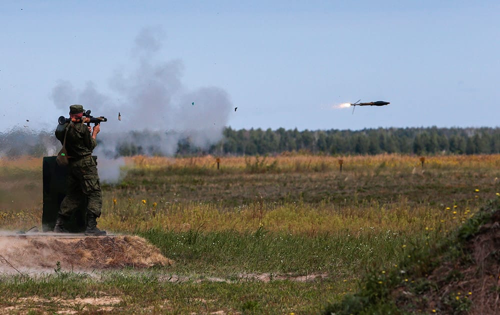 A Russian paratrooper fires a weapon during the 