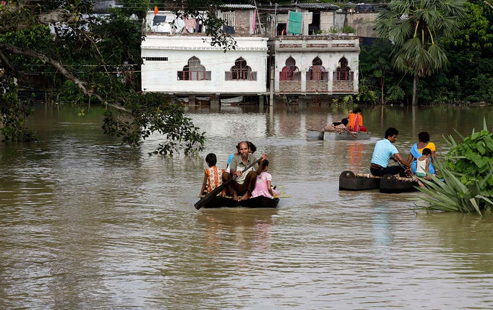 Villagers wade through floodwaters as they travel on a boat to safer areas in Ghatal, about 120 kilometers (75 miles) west of Kolkata.