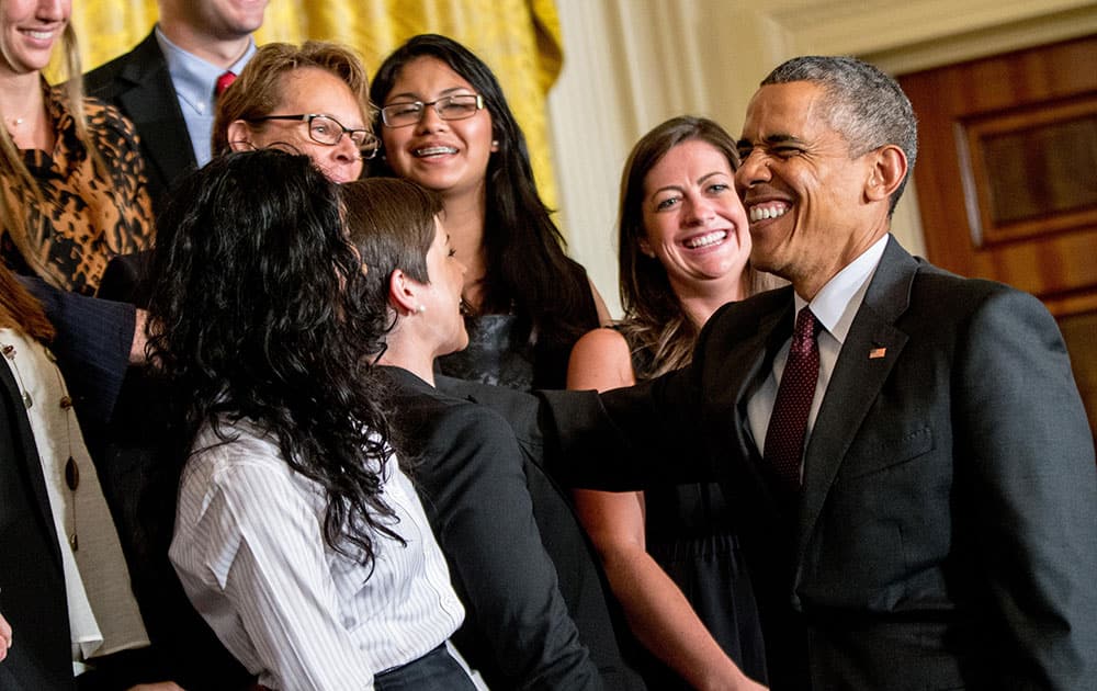 President Barack Obama reacts as the audience sings him 