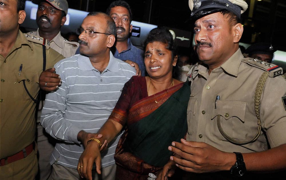 Vijay Kumar, one of the teachers who were kidnapped in Libya allegedly by Islamic State, arrives at Kempegowda International Airport in Bengaluru. His wife can also be seen in the picture.