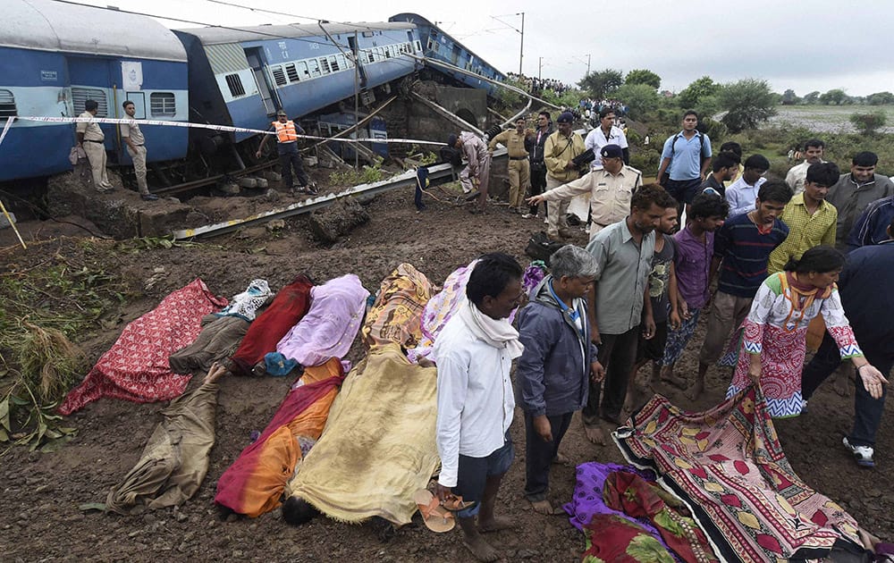 People try to identify relatives near the wreckage of Kamayani Express and Janata Express trains which derailed within minutes of each other while crossing a small bridge at Harda in Madhya Pradesh.