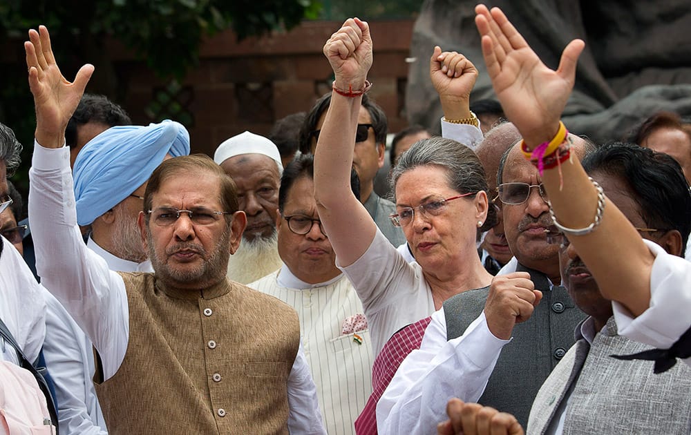 Opposition Congress party president Sonia Gandhi and other lawmakers shout slogans against the government during a protest in the parliament premises in New Delhi. The opposition has been demanding that two leaders of the ruling Bharatiya Janata Party resign for allegedly helping a former Indian cricket official facing investigation for financial irregularities.