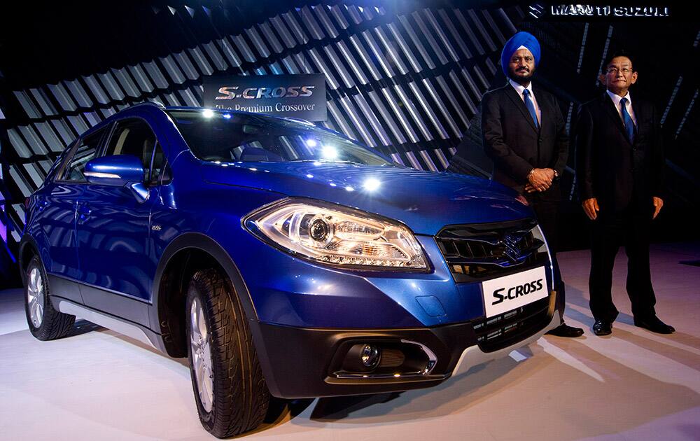 Maruti Suzuki India officials, Managing Director and CEO Kenichi Ayukawa and Executive Director, marketing and sales, Randhir Singh Kalsi, pose with the new Maruti Suzuki, S-Cross car, during its launch in New Delhi, India.