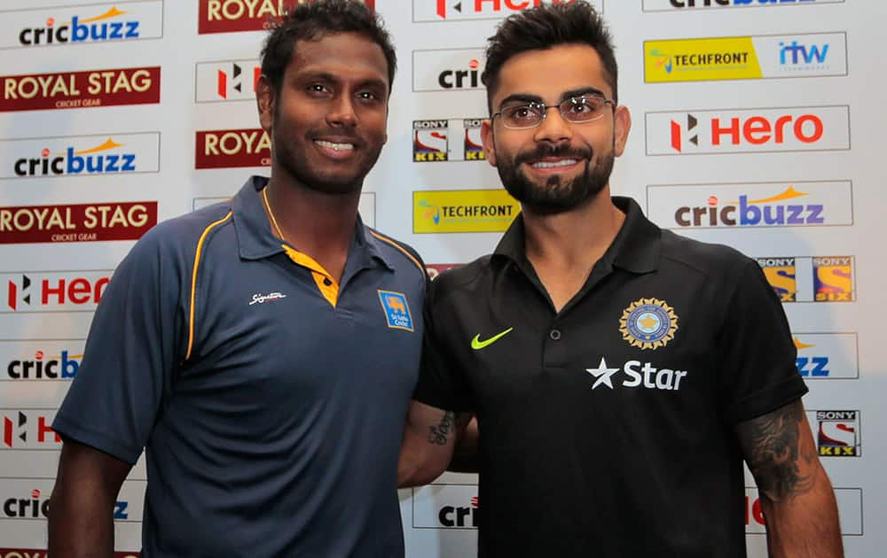 Sri Lanka's captain Angelo Mathews and his Indian counterpart Virat Kohli pose for photographers during a press conference ahead of their three test match series in Colombo, Sri Lanka. India plays against South Africa in their first test match series beginning Aug. 12.