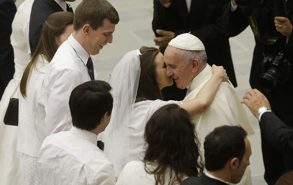 Pope Francis greets newlyweds during the general audience in the Paul VI hall at the Vatican.