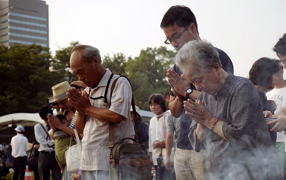 Buddhist monks pray for the atomic bomb victims in front of the cenotaph at the Hiroshima Peace Memorial Park in Hiroshima, western Japan.