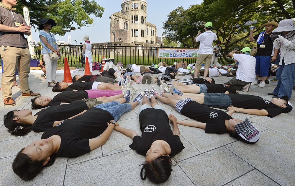 Children stage a die-in in front of the Atomic Bomb Dome in Hiroshima, western Japan at 8:15am, the time atomic bomb exploded over the city, on the 70th anniversary of the atomic bombing of Hiroshima.