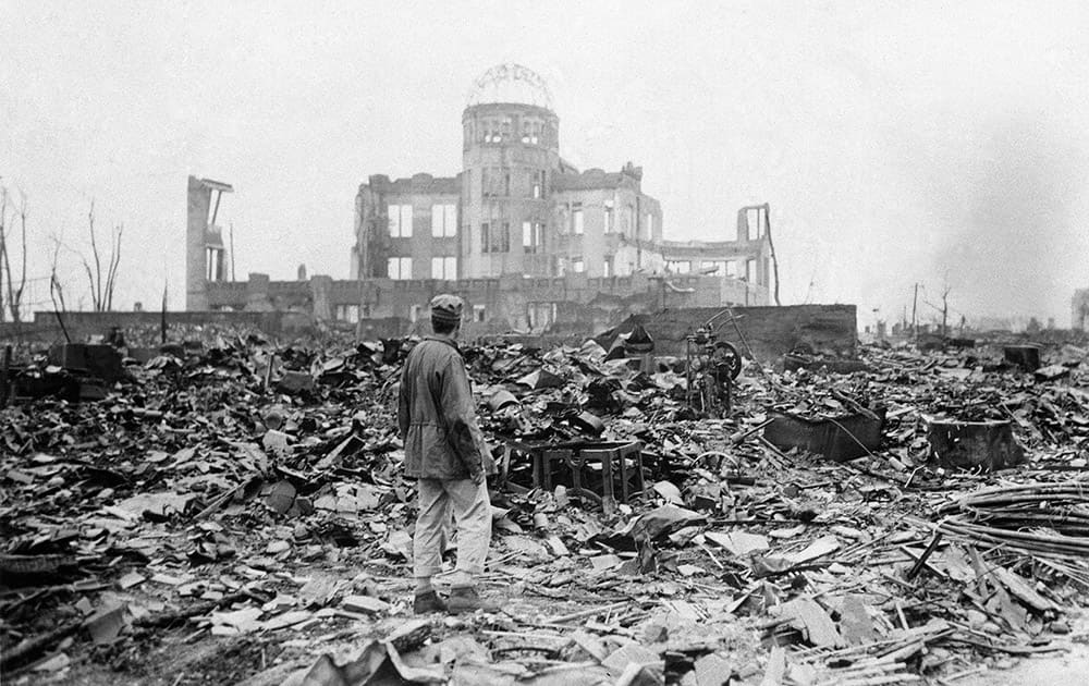 FILE PHOTO - In this Sept. 8, 1945, an allied correspondent stands in the rubble in front of the shell of a building that once was a exhibition center and government office in Hiroshima, Japan, a month after the first atomic bomb ever used in warfare was dropped by the US on Aug. 6, 1945.