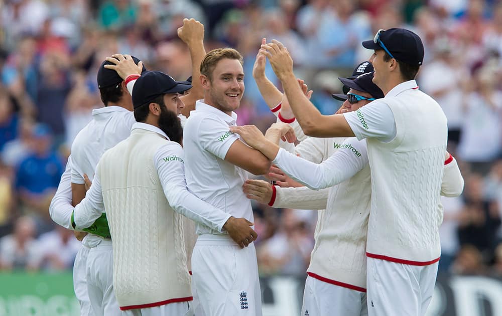 England's Stuart Broad, celebrates with teammates after his 300th test wicket, that of Australia's Chris Rogers caught by Alastair Cook for 0, on the first day of the fourth Ashes test cricket match between England and Australia at Trent Bridge cricket ground in Nottingham, England.