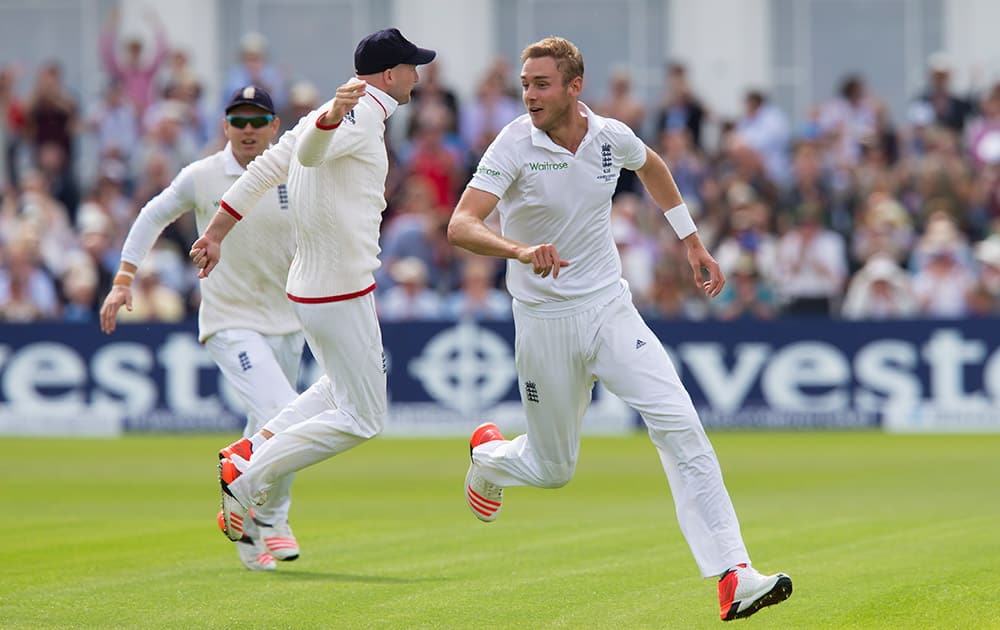 England's Stuart Broad, right, celebrates taking the wicket of Australia's Steve Smith caught by Joe Root for 0 on the first day of the fourth Ashes test cricket match between England and Australia at Trent Bridge cricket ground in Nottingham.