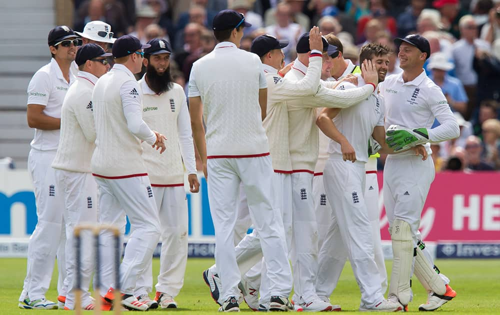 England's Mark Wood, celebrates with teammates after taking the wicket of Australia's David Warner, caught by Jos Buttler for 0, on the first day of the fourth Ashes test cricket match between England and Australia at Trent Bridge cricket ground in Nottingham.