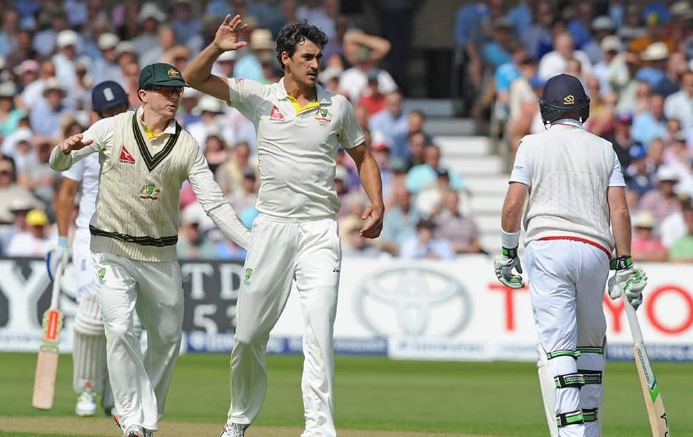 Australia’s Mitchell Starc, centre, celebrates with Chris Rogers , left, after trapping England’s Ian Bell, right, LBW for 1 run during day one of the fourth Ashes Test cricket match, at Trent Bridge, Nottingham.