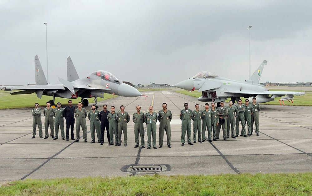 An Indian Air Force contingent poses for a photograph in front of the Sukhoi-30 and the Typhoon at the close of the joint Exercise Indradhanush-IV at RAF Coningsby, in United Kingdom recently.