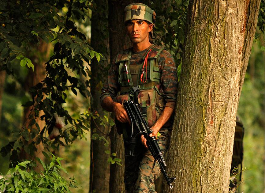 Army soldier takes position near the site of a gunbattle in Pulwama, from Srinagar. A suspected rebel of Lashkar-e-Taiba (LeT) group was killed in a gunfight with security forces in Jammu and Kashmir's Pulwama district.