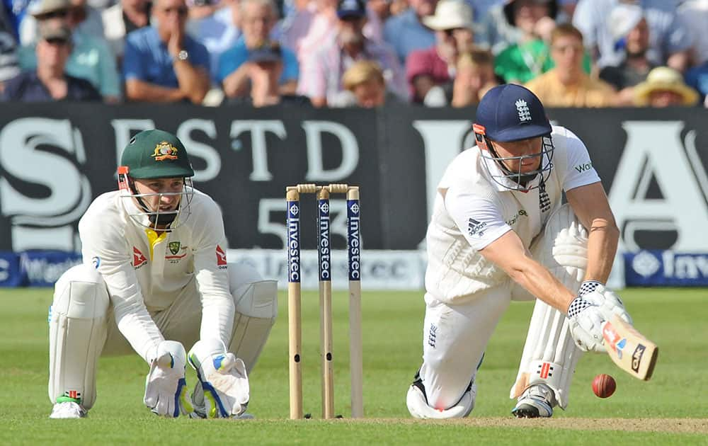 England's Jonny Bairstow, right, sweeps watched by Australia’s Peter Nevill during day one of the fourth Ashes Test cricket match, at Trent Bridge, Nottingham.