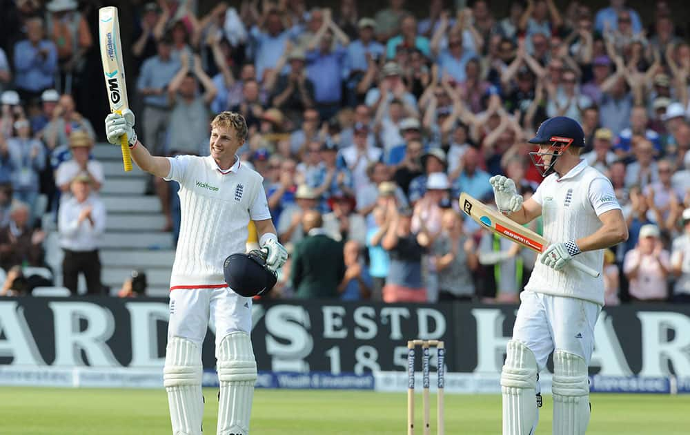 England’s Joe Root is applauded by Jonny Bairstow, right, as he celebrates after reaching a century during day one of the fourth Ashes Test cricket match, at Trent Bridge, Nottingham.