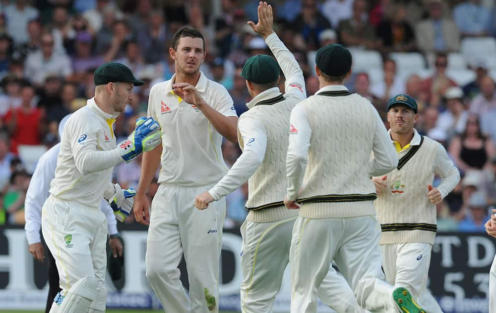 Australia’s Josh Hazlewood, 2nd left, celebrates after bowling England's Jonny Bairstow caught by Australia’s Chris Rogers for 74 runs, during day one of the fourth Ashes Test cricket match, at Trent Bridge, Nottingham.