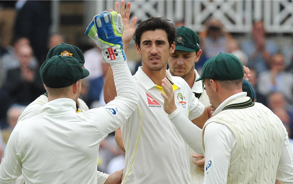 Australia’s Mitchell Starc celebrates with teammates after bowling England’s Joe Root caught Australia’s Peter Nevill for 130 runs during day two of the fourth Ashes Test cricket match, at Trent Bridge, Nottingham, England.