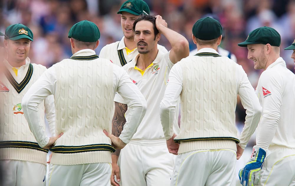 Australia's Mitchell Johnson stands amongst teammates after taking the wicket of England's Moeen Ali caught by Steven Smith for 38 on the second day of the fourth Ashes test cricket match between England and Australia at Trent Bridge cricket ground in Nottingham, England.