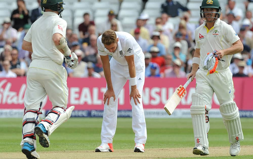 England’s Stuart Broad reacts as Australia’s David Warner and Chris Rogers run between wickets during day two of the fourth Ashes Test cricket match, at Trent Bridge, Nottingham, England.