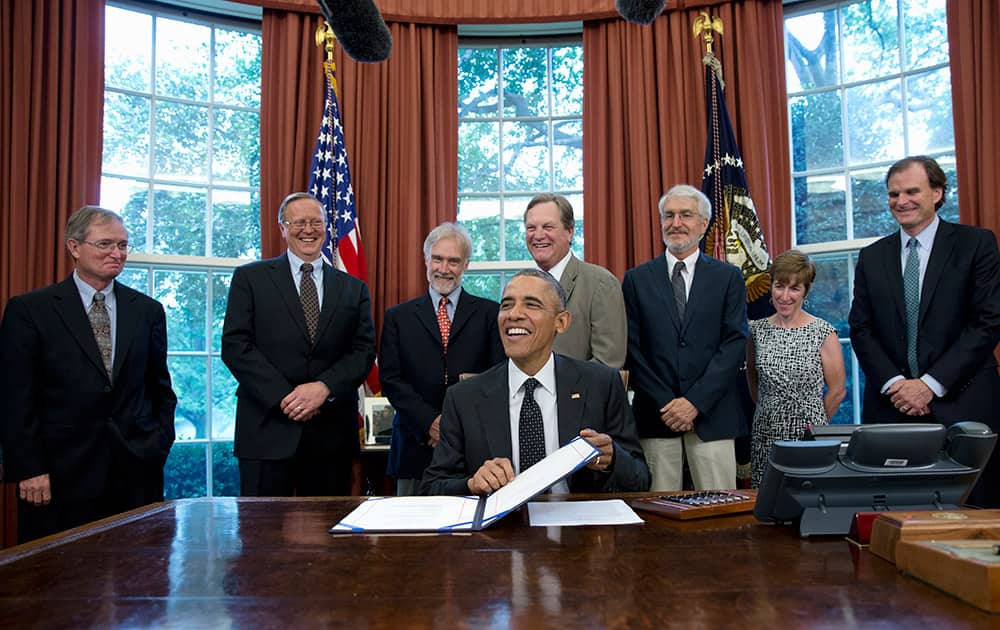 President Barack Obama smiles as he prepares to sign H.R. 1138 Sawtooth National Recreation Area and Jerry Peak Wilderness Additions Act, in the Oval Office of the White House in Washington.
